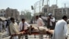 Volunteers transport an injured victim at the scene of the suicide car-bomb attack in Lahore on May 27. 