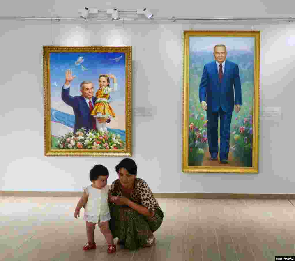 Visitors inside the gallery. A worker at the museum told RFE/RL that most of the paintings were taken from Karimov&rsquo;s own walls, while others were commissioned for the exhibition.