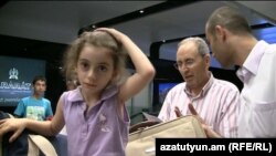 Armenia -- A Syrian Armenian girl from Aleppo at Yerevan's Zvartnots airport, 25Jul2012.