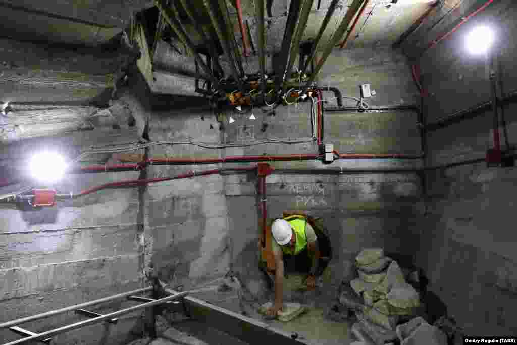 A worker climbs inside the statue during the renovation. The steel cords at the top of the image are part of a network of sinew-like cables that strengthen the monument and can be tightened by engineers.