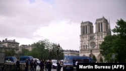 French police gather at the entrance to Notre-Dame Cathedral in Paris following an attack on an officer on June 6.