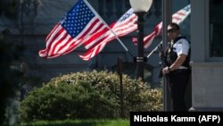 A U.S. Secret Service agent stands guard at the White House, which went into lockdown after a shooting incident on March 28.