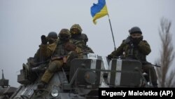 Ukrainian soldiers atop an APC near Donetsk (file photo)