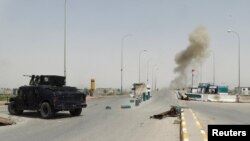 Smoke rises during clashes between Iraqi security forces and Islamic State militants on the outskirts of Ramadi on April 9.