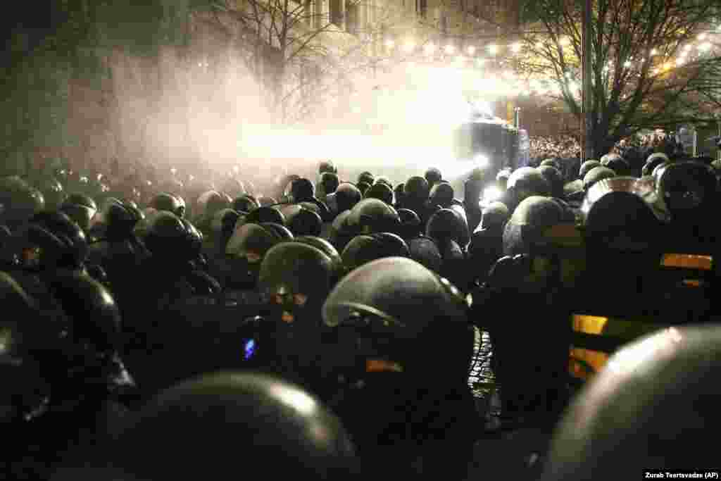 Police use water cannons against demonstrators outside the Georgian parliament building in Tbilisi on November 26. Thousands demonstrated to demand that the government step down amid demands for electoral reform. (AP/Zurab Tsertsvadze)