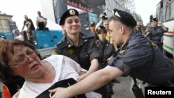 Police detain an opposition protester during a rally in Moscow on May 31.