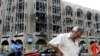 An Iraqi weeps as he walks away from the Justice Ministry following the bombing.