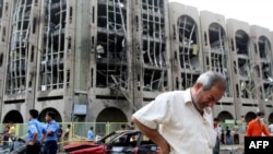 An Iraqi weeps as he walks away from the Justice Ministry following the bombing.