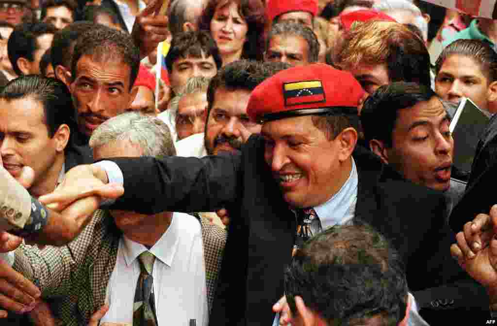 Retired Lieutenant Colonel Hugo Chavez, who led a coup attempt in February 1992, is greeted by supporters in Caracas in July 1997.