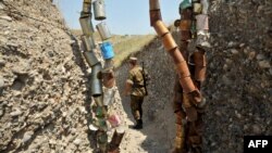 Nagorno-Karabakh -- An Armenian soldier of the self-proclaimed republic of Nagorno-Karabagh walks in a trench at the frontline on the border with Azerbaijan near the town of Martakert, 06Jul2012