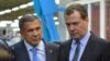 Russian Prime Minister Dmitry Medvedev (right) and Tatar President Rustam Minnikhanov have engaged in a war of words over the order to extract more revenue from Russia's regions.
