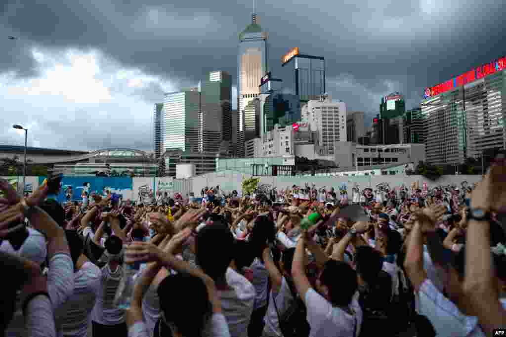 Protesters gesture as they chant "no extradition" at a rally against a controversial extradition-law proposal in Hong Kong on June 9. (AFP/Philip Fong)