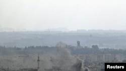 Smoke rises from the Syrian city of Latakia on August 14.