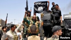 Iraqi security forces pull down a flag belonging to Sunni militant group Islamic State of Iraq and the Levant (ISIL) during a patrol in the town of Dalli Abbas in Diyala Province on June 30.