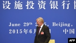 Russian Deputy Finance Minister Sergei Storchak leaves after signing an article of association to help set up the Asian Infrastructure Investment Bank (AIIB) during a ceremony at the Great Hall of the People in Beijing on June 29.