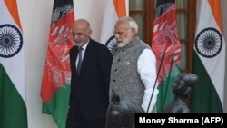 Indian Prime Minister Narendra Modi (right) and Afghan President Mohammad Ashraf Ghani walk together before a meeting in New Delhi on October 24.