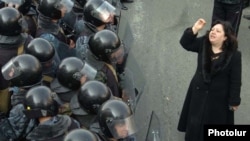 A woman confronts rows of riot police in downtown Yerevan on March 1, 2008.