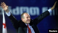 Giorgi Margvelashvili, the presidential candidate of the ruling Georgian Dream coalition, waves to supporters during a presentation of his election program in Tbilisi on September 19.