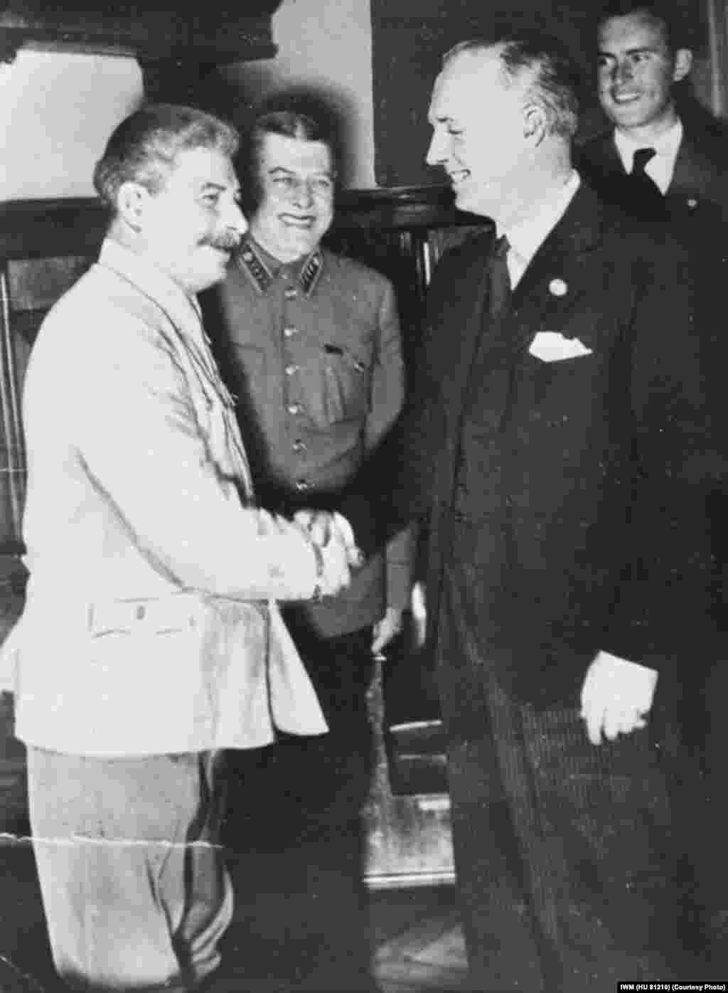 Von Ribbentrop shakes hands with Stalin after signing the Treaty of Friendship, Cooperation, and Demarcation, the continuation of the nonaggression pact.
