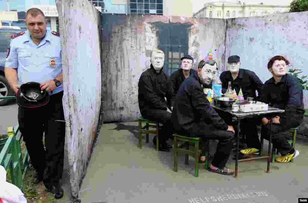 Members of a pro-Kremlin youth group wear masks representing anti-Putin opposition leaders during a demonstration called "Send them to join Khodorkovsky as guests!" on the occasion of the jailed businessman's 50th birthday.