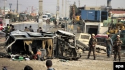 Afghan security officials inspect the scene of a suicide bomb attack that targeted a British Embassy vehicle in Kabul on November 27.