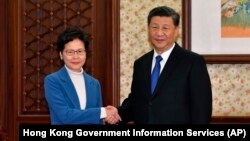 Șefa executivului din Hong Kong, Carrie Lam, și președintele Chinei, Xi Jinping, decembrie 2019