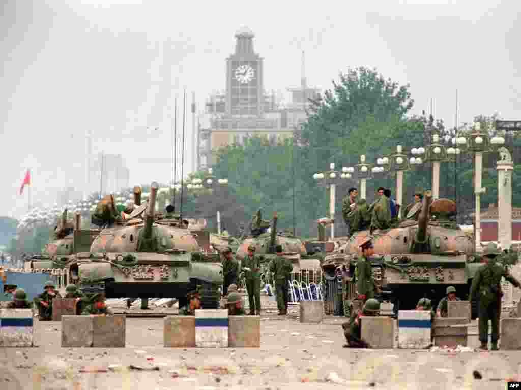 China -- Tanks and soldiers guard the strategic Chang'an Avenue leading to Tiananmen Square two days after their crackdown on pro-democracy students, Beijing, 06Jun1989 - CHINA, Beijing : (FILES) This file photo taken on June 6, 1989 shows People's Liberation Army (PLA) tanks and soldiers guarding the strategic Chang'an Avenue leading to Tiananmen Square in Beijing two days after their crackdown on pro-democracy students. Hundreds, possibly thousands, of protesters were killed by China's military on June 3 and 4, 1989, as communist leaders ordered an end to six weeks of unprecedented democracy protests in the heart of the Chinese capital.