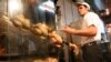 Iran -- A cook grills chickens in a shop in Tehran, 19Oct2012