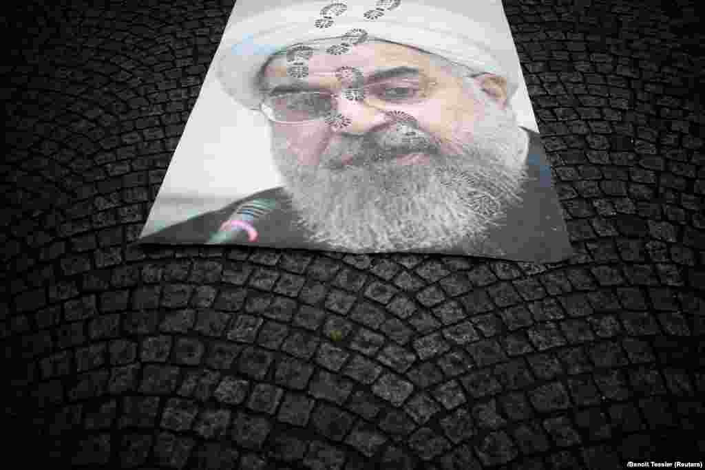 A portrait of Iran's President Hassan Rohani lays on a street as thousands of Iranian opponents in exile staged a protest in Paris against the Tehran regime, before the 40th anniversary of the Islamic Revolution. (Reuters/Benoit Tessier)