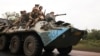 Ukrainian servicemen travel on a wheeled BTR fighting vehicle near Bakhmut.