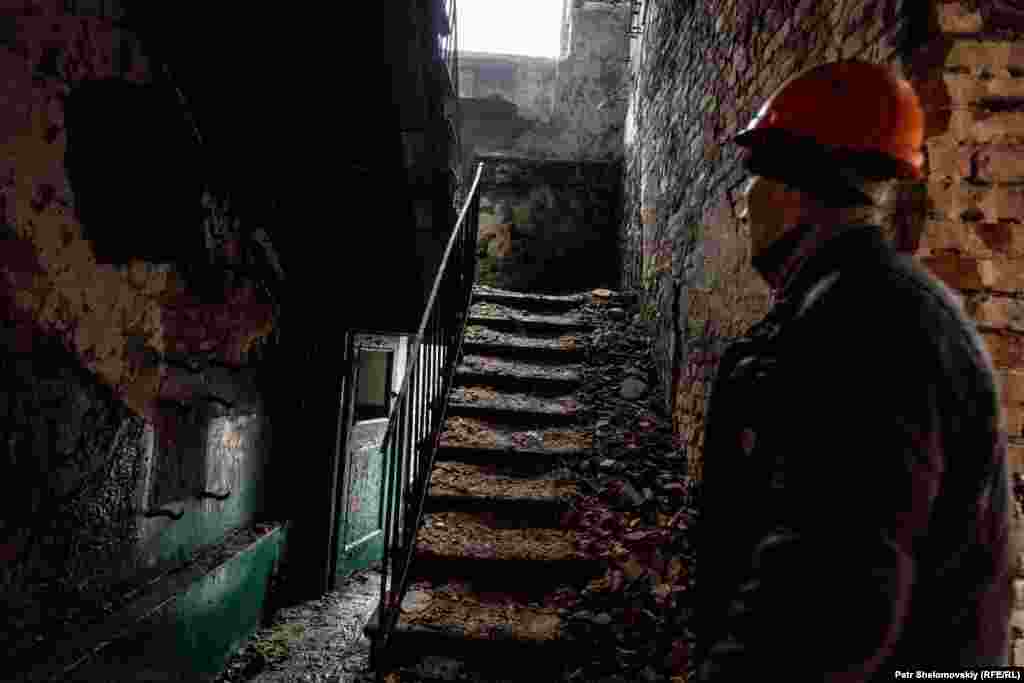 A construction worker inside a destroyed building