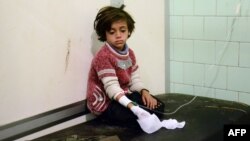 An injured child waits after receiving treatment at a hospital in a government-held neighborhood in the northern city of Aleppo on November 3.