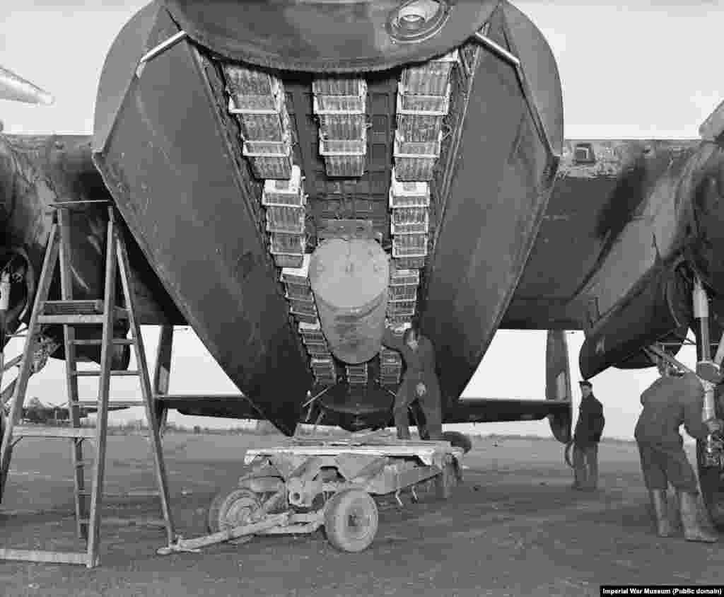 A British Lancaster bomber being fitted with sticks of fire-starting incendiaries and one &quot;blockbuster&quot; bomb. At around 10 p.m. on February 13, 1945, 244 Lancasters rained this combination of incendiary and high explosives onto Dresden. &nbsp;