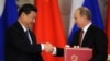 Russian President Vladimir Putin (right) shakes hands with his Chinese counterpart, Xi Jinping, during a document-signing ceremony in Moscow in March.