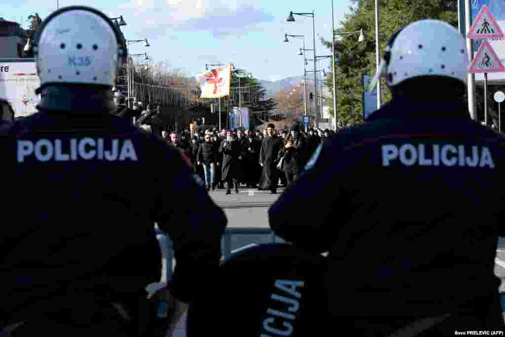 Serbian Orthodox Church clergy and believers stand in front of police on a bridge near parliament, ahead of the vote on a controversial law on religious freedom, in Podgorica, Montenegro, on December 26. (AFP/Savo Prelevic)