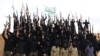 Syrian Islamist fighters hold up their weapons during a graduation ceremony at a camp in eastern al-Ghouta, near Damascus.