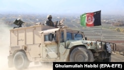 Afghan security officials patrol during an operation in Khogiani district of Nangarhar Province.