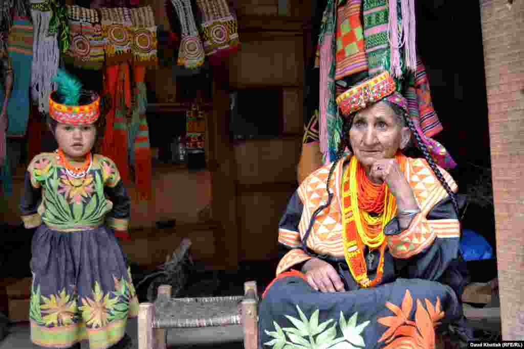 A woman selling Kalash clothing. After slowly declining in numbers, recent years have shown a slight increase in the population of the Kalash to around 4,000, but their culture faces pressure from many fronts.