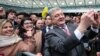 Ukrainian President Petro Poroshenko takes selfies with supporters at Olimpiyskyi Stadium in Kyiv on April 14.