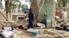 Residents look through the debris of a house, which collapsed after the earthquake hit the Awaran district in Balochistan Province.