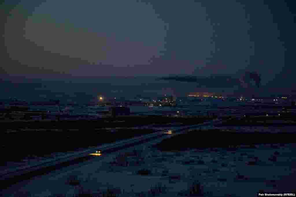 A Vorkuta landcape with smoke rising from a coal-powered electricity plant in the background