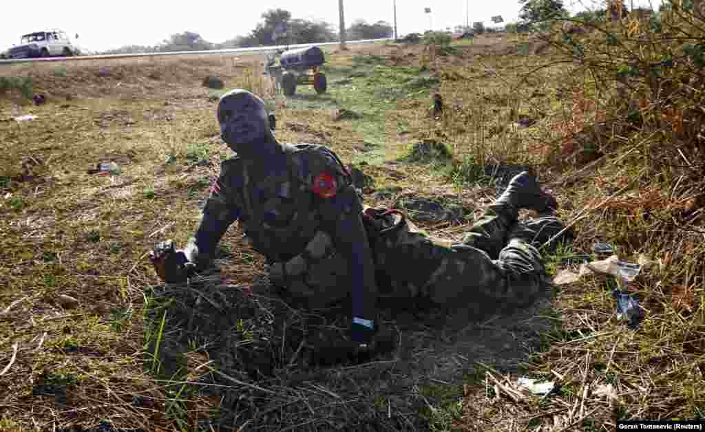 A soldier looks for warplanes during an air strike by the Sudanese air force that killed three people near Bentiu, South Sudan, in April 2012.