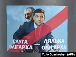 A placard depicting then-Ukrainian entertainer and presidential candidate Volodymyr Zelenskiy (right) and oligarch Ihor Kolomoyskiy in Lviv on February 8.