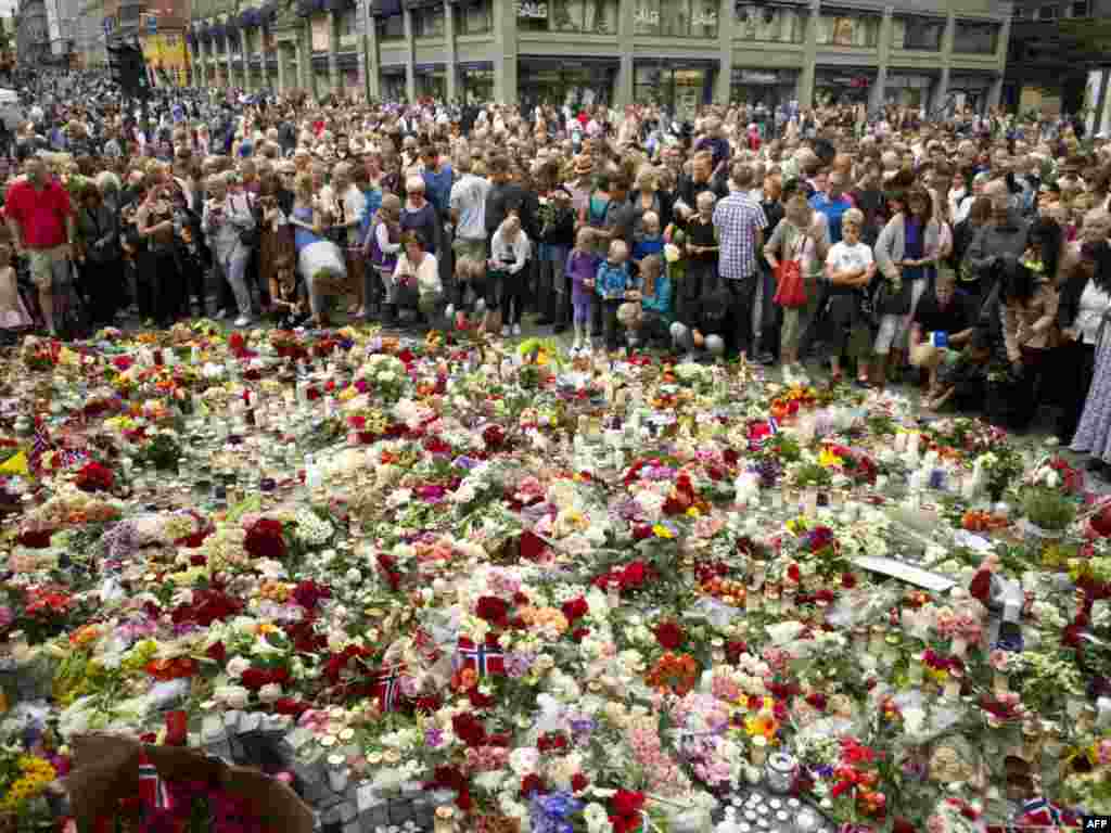 Mourners crowd around a floral tribute in the Norwegian capital, Oslo, to the victims of the July 22 bomb explosion that ripped through government buildings and a related shooting spree at a political youth camp. Photo by Odd Andersen for AFP