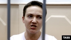 Detained Ukrainian helicopter pilot Nadia Savchenko stands inside the defendant's cage during a hearing in the Basmanny district court in Moscow in November 11.