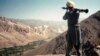 A fighter watches a Soviet bombardment hammer an Afghan valley. A bloody communist coup in Afghanistan in 1978 was followed a year later by a full-scale invasion by the U.S.S.R.