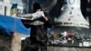 A man reads a newspaper on Kyiv's Independence Square on February 24. Demonstrators have begun to trickle away from the tent camp, seemingly eager to return to a normal routine after weeks of freezing vigils and pitched battles with riot police and thugs.