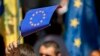 People wave EU flags in front of Moldova's parliament during the ratification of the Association Agreement between Moldova and EU in July, 2014.