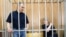 Former Yukos oil company CEO Mikhail Khodorkovsky (left) and Platon Lebedev in a Moscow courtroom -- will they receive more than moral compensation?