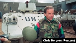 Then-U.S. Senator Joe Biden speaks to reporters in front of a Danish UN armored personnel carrier at the airport in Sarajevo on April 9, 1993.
